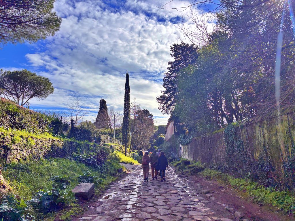 Visitors walking along the ancient Appian Way (Via Appia Antica) in Rome